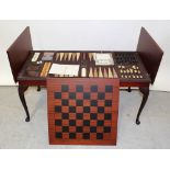 A contemporary mahogany coffee table with central leaf which flips up to reveal a games compendium