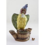 A 19th century decorative Majolica bowl in the form of a tree trunk with a large parrot to the