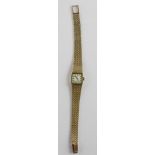 Rotary; a 9ct gold ladies wristwatch with square baton dial, on textured 9ct gold strap, approx 29.