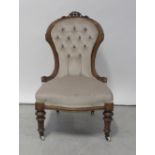 A 19th century walnut-framed nursing/spoon-back chair.