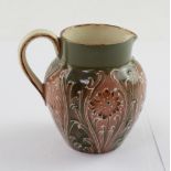 James MacIntyre Burslem; a jug, green ground with tube-lined floral decoration,