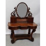 A Victorian mahogany Duchess dressing table, central oval mirror,