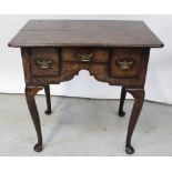 A late 18th/early 19th century oak lowboy, one frieze drawer with drawer to either side,