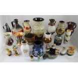 A quantity of West German pottery vases, three Hummel figures and a Hummel bird figure.