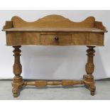 A Victorian walnut twin pillar wash stand with shaped galleried back and single central frieze