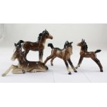 Three varying sized Beswick horses and a similar style horse (one af) (4).