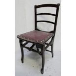 An Edwardian mahogany-framed children's folding deck chair with red faux leather seat,