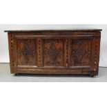 A 17th century burr oak chest, lift up top over three raised carved panels,