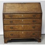 A 19th century oak bureau, drop-down desk top with interior drawers and pigeonholes,