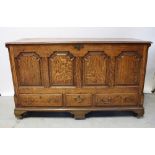 An 18th century three drawer mule chest with arched panels to the front and plain pilaster columns,