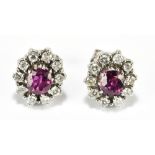 A pair of white metal diamond and ruby oval floral cluster ear studs, estimated ruby weight 1.50cts,