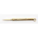 A 9ct gold propelling toothpick by Cohen & Charles, 55mm long