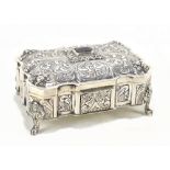 An 800 grade silver casket of shaped rectangular form, possibly Italian, with chased scrolling