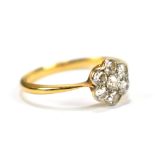 An 18ct yellow gold and diamond floral cluster seven stone ring, size O, approx 2.3g