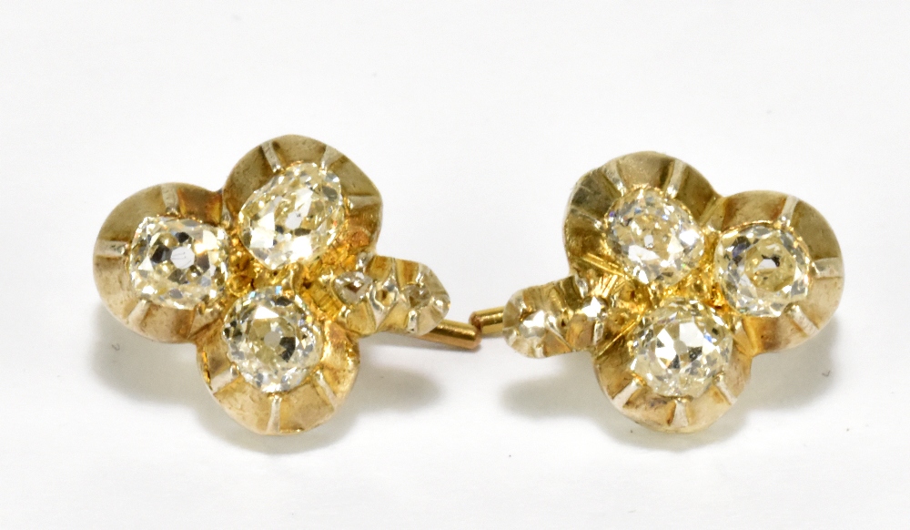 A pair of yellow metal and diamond set trefoil earrings, head length approx 12mm, approx 3.5g.