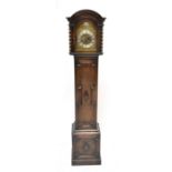 A 1930s oak grandmother clock with arched dial inscribed 'Tempus Fugite', height 160cm.