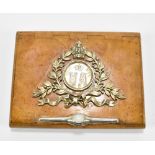 A Russian birch cigarette case with applied silver decoration depicting a crown above foliate,