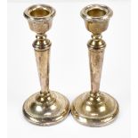 A pair of Elizabeth II loaded hallmarked silver candlesticks, Birmingham 1970, height 15.5cm (2).