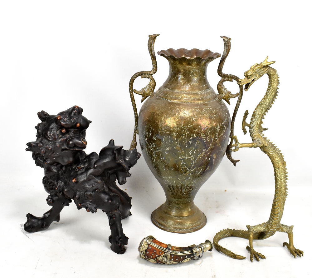 An Eastern brass twin handled vase with cobra handles, a brass dragon, a rootwood carving of a chi