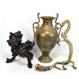 An Eastern brass twin handled vase with cobra handles, a brass dragon, a rootwood carving of a chi