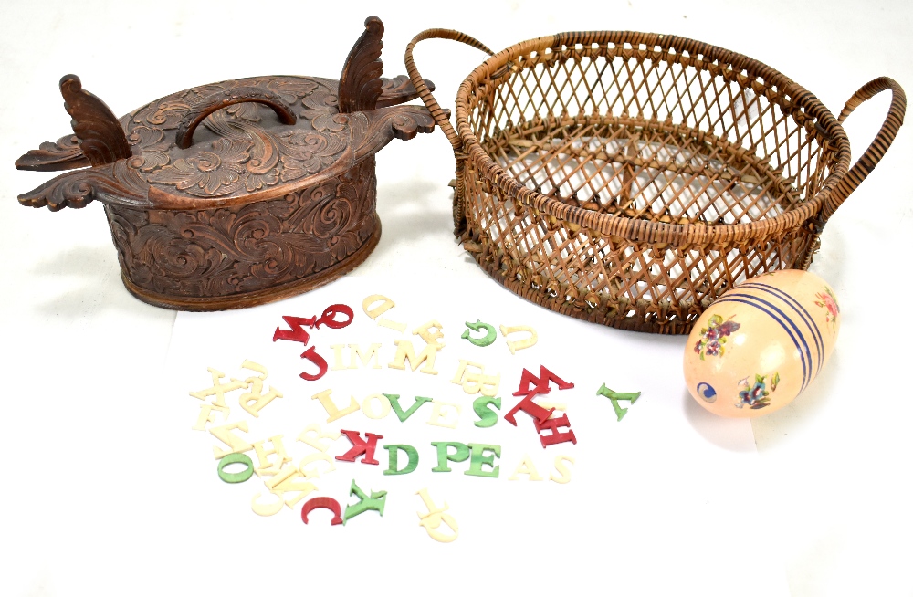 A group of ivory and stained ivory letters in a floral painted egg, a floral carved Norwegian wooden