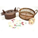 A group of ivory and stained ivory letters in a floral painted egg, a floral carved Norwegian wooden