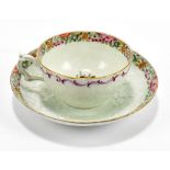 WORCESTER; an 18th century first period cup and saucer decorated in the 'Packling Parrot' pattern,