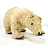 An early to mid-20th century polar bear in blonde mohair, stitched nose and mouth, cloth pads and