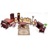 A collection of dolls house dining room and sitting room furniture including organ, longcase