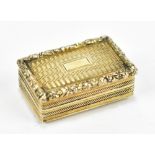 A George IV hallmarked silver pill box of rectangular form with gilt washed detail and foliate