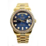ROLEX; an 18ct gold Day Date wristwatch, the bezel set with diamonds and dial with diamond numerals,