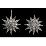 A pair of cased white metal diamond set sunburst earrings, diamond weight estimated totalling approx