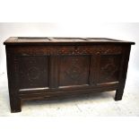 An 18th century carved oak three panel coffer, width 128cm.