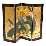 A 20th century black lacquered and gilt heightened Oriental four section folding screen decorated