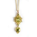 A yellow metal floral drop pendant suspended on a fine link chain, length of drop 3.7cm.