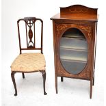 An Edwardian inlaid mahogany music cabinet, the single door with glazed section and raised on