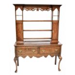 A 19th century oak open back dresser with three fixed shelves flanked by two inlaid doors, the
