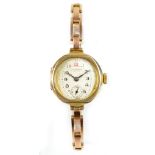 JW BENSON OF LONDON; a 9ct yellow gold lady's wristwatch, the silvered dial set with Arabic numerals