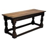 An 18th century and later oak refectory table, with carved undertier section and raised on