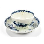 WORCESTER; an 18th century first period feather moulded tea bowl and saucer decorated with floral