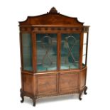 A good early 20th century rosewood display cabinet with floral carved and inlaid gallery above blind