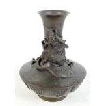 A Chinese bronze vase decorated with a dragon chasing the Pearl of Wisdom with lotus shaped panels