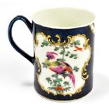 WORCESTER; an 18th century first period mug with blue scale ground and vignettes decorated with