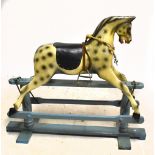 A late 19th/early 20th century dappled grey painted rocking horse, with tack and on blue painted