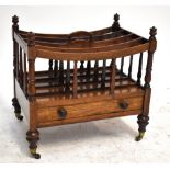 A Victorian rosewood Canterbury with single drawer to base, on brass castors, height 49cm.