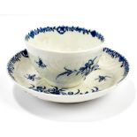 WORCESTER; an 18th century first period feather moulded tea bowl and saucer decorated with floral