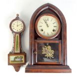 An early 20th century American mantel clock of arched form, the circular dial set with Roman