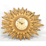 SMITHS SECTRIC; a gilt framed sun burst wall clock set with Arabic numerals, width 61cm.