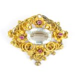 A yellow metal aquamarine and ruby set brooch, unmarked, approx 12.2g.