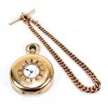 A 9ct yellow gold crown wind half hunter pocket watch, the enamelled dial set with Roman numerals